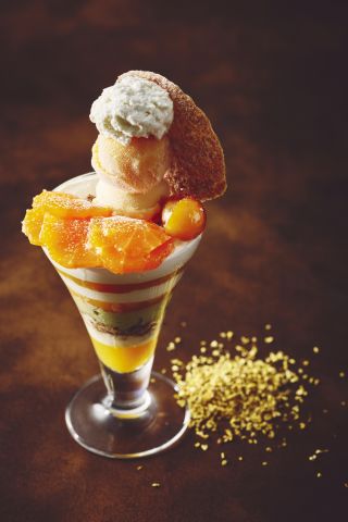 A Glass Of Ice Cream With A Slice Of Orange On Top