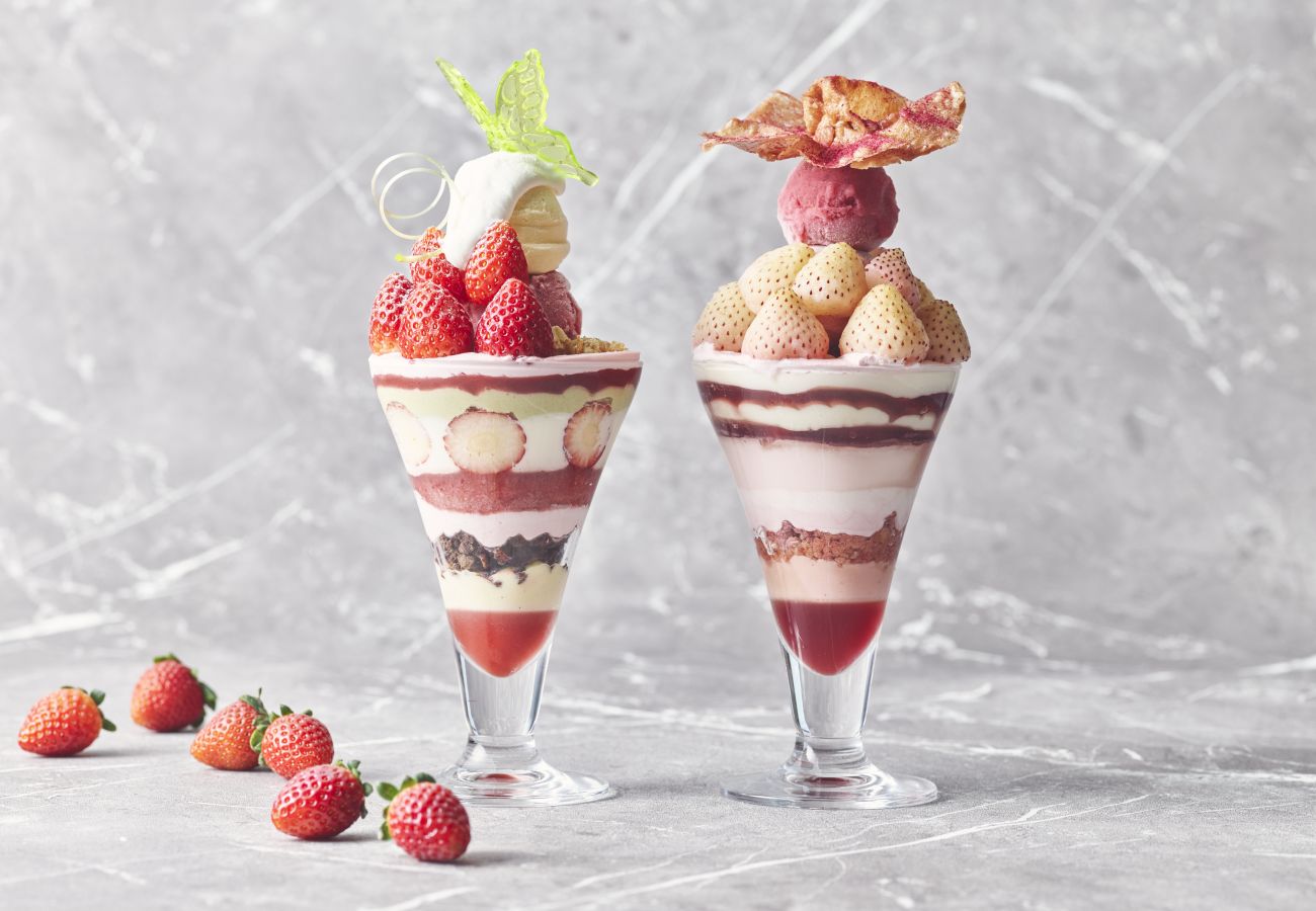 Two Glasses With Strawberries And A Dessert In Them