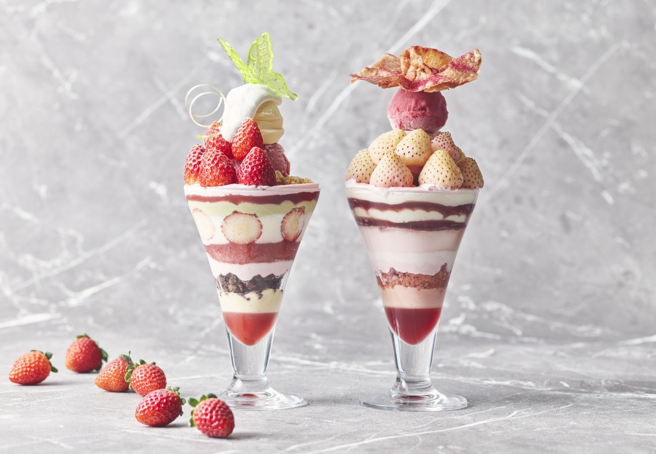 Two Glasses With Strawberries And A Dessert In Them