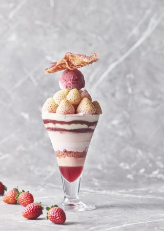 A Glass Of Ice Cream With Strawberries And A Slice Of Bread On Top