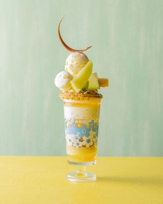 A Glass With A Fruit And Ice Cream In It